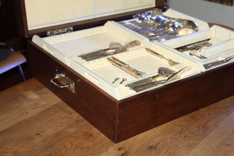 An open large cutlery canteen with cutlery in pale inserts